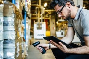 Warehouse worker scanning inventory with a handheld scanner